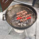 Laying the meat upon the grill.