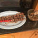 Threading the meat (and cherry tomatoes) upon their skewers.