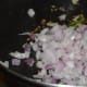 Step three: Add chopped onions and chopped green chilies. Saute till onions become transparent.