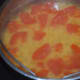 Step two: Cook split pigeon peas and tomatoes in a pressure cooker. Mash them.