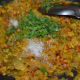 Step ten: Add some chopped coriander leaves and mix. Stir-cook for two minutes. Transfer the curry into a serving dish.