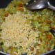 Step six: Add soaked yellow lentils (moong dal). Mix and cook for 3-4 minutes or till the mix becomes a bit dry. Add a cup of water.