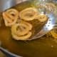 Step seven: Gently drop 6-7 of them into the hot oil. Fry on medium low fire till they get golden brown. Ensure that they cook all the way through. Frying each batch may take about 6 minutes. Take them out and place on a paper.