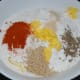 Step three: In a mixing bowl, add the white lentil paste, rice flour, butter, sesame seeds, cumin seeds, red chili powder, hing, and salt. Knead while adding water if needed to get a pliable smooth dough.