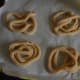 Step six: Make raw thiengolu shapes on a greased plastic sheet