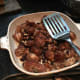 The sautéd meat combined with the raisins and the almonds.