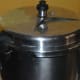 Cover the cooker with the lid and place the weight. Cook for up to 4 whistles and simmer for 2–3 minutes.