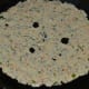 Step 3: Heat a pan ad add a few drops of oil to it. Place the flatbread in the center and add some oil on the surface. Cook it on medium-low heat until the bottom side becomes crispy, then flip.