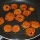 Step six: Shallow-fry them on a low fire for 3 to 4 minutes. By this time, the slices should be roasted on the bottom. Now, flip them. Add a few drops of oil on the top.
