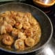Delicious shrimp simmering in seasoned butter.