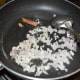 Step five: Saute cinnamon stick and cardamom in some oil for 5 seconds. Add onions. Saute till they turn translucent.
