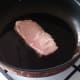Pork steak is gently fried in a little oil