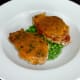 Spicy cheese pork steak tops each curried potato half