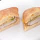 Pork steak sandwich is halved to serve