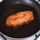 Marinated pork steak is gently shallow fried