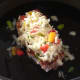 Spicy cheese and peppers mix is scattered over pork steak