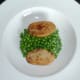 Fried potato and peas are plated