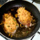 Spicy cheese mix is scattered over pork steaks