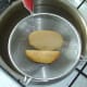 Potato pieces are drained and left to cool