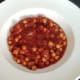 Curried chickpeas are poured in to serving plate