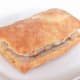 Top of ciabatta is pressed down lightly on pork steak