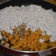 Boil coconut-jaggery mix, adding some water.