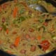 Sauté onions in some oil in the same pan. Add the chopped veggies and stir-cook for 2–3 minutes. Add 4 glasses of water and some salt. Bring it to boil. Add the roasted vermicelli. Cook them covered on a low fire for 4–5 minutes.