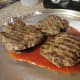 The grilled hamburgs placed on the grilled mushroom caps.