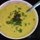Step five: Add the tempering.Heat ghee/oil in a small pan. Add mustard seeds, white lentils, curry leaves, and hing powder. Saute till mustard crackles. Mix well. Pour it on the raita. Garnish with chopped coriander leaves.