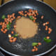 Step three: Add puliyogare mix. Lower the heat to minimum. Stir it once. Add grated carrots if you are using. I cooked carrot cubes with the rice.