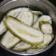 Step one: Wash raw bananas. Peel the skin. Slice them lengthwise to get long pieces. Immerse the slices in water and drain.