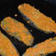 Step five: Heat a pan for shallow-frying. Add some oil. Dip the banana slices into the paste and then place them in the hot pan.