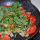 After the tomatoes are soft, add the spinach and dried parsley while stirring occasionally. Allow to cook until the spinach has started to wilt.