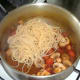 Drained spaghetti is added to sauce