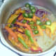 Peppers are added to softened onion and garlic