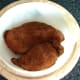 Spiced chicken breasts are laid in casserole dish