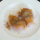 Turmeric and black pepper are scattered over chicken breasts