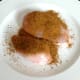 Bolognaise spice is scattered over chicken breasts