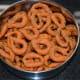 Step four: Make small rings out of them, as per instructions. Deep-fry them in batches of 8-10, in medium-high hot oil. Take them out when they become crispy. Place them on an absorbent paper. Repeat the same for making all the kodubale.
