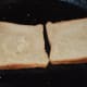 Heat a flat pan and grease it with butter or oil. Place 2 or 3 bread slices on it and roast the bottom sides.