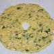Step 5: Divide the dough into four equal portions. Make a patty out of one of the portions on a greased plastic sheet. Apply water to your fingers and expand it to make a disc of about six inches in diameter. Make a big hole in the center.