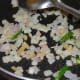 Step 3: Heat oil in a deep-bottomed pan. Throw in chopped onions, ginger, and green chilies. Saute until onions become golden brown.