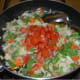 Step five: Add chopped tomatoes. Continue stir-cooking till tomato becomes soft.