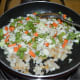 Step four: Throw in mixed veggies. Add salt. Stir-cook for 4 to 5 minutes.