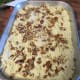 Dot the cake mix layer with chopped pecans.