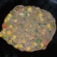 Add a few drops of oil or ghee on the top and edges, then cover the pan for a minute while keeping the heat on medium-low.