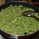 Add the chopped long beans. Add the salt and sugar and mix well. Sauté on medium-low heat for 4–5 minutes.