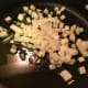 Add onions and garlic to heated olive oil.