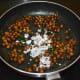 Throw in grated coconut. Thoroughly mix once again. Turn off the fire. Your chickpea stuffing is ready.
