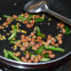Step two: Add slit green chilies. Saute for a while. Lower the heat.